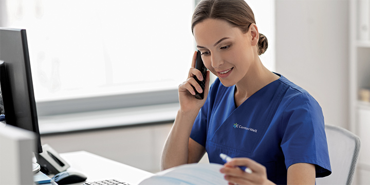 Female clinician happily receives patient calls at the office